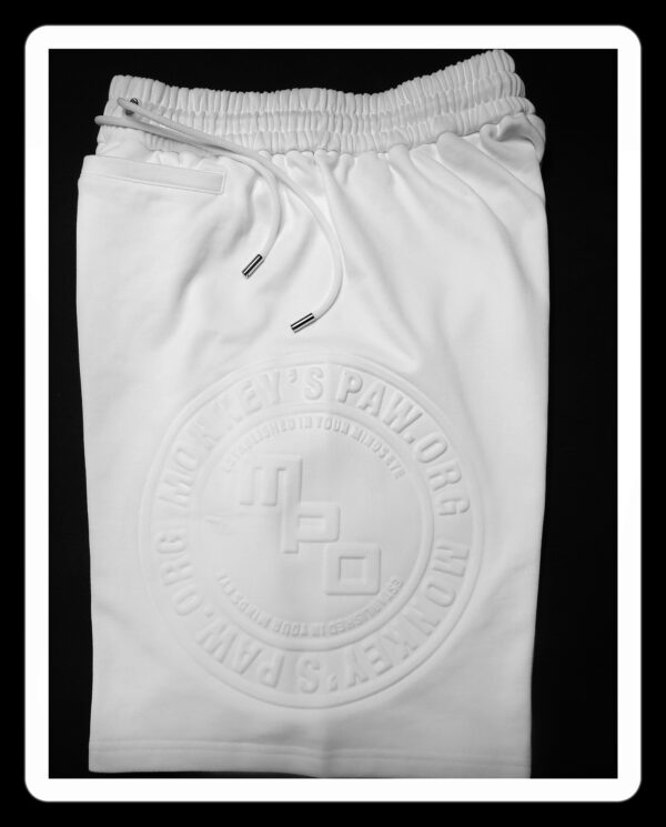 A white pair of shorts with an emblem on the front.